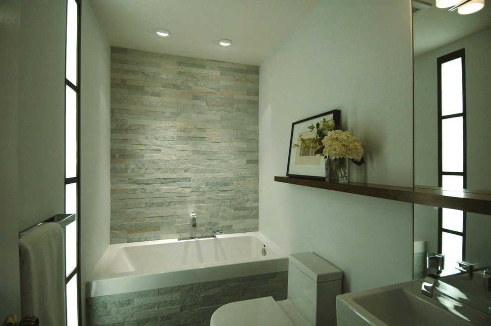 Alcove bathtub - small modern 3/4 stone tile and gray tile slate floor alcove bathtub idea in San Francisco with an integrated sink, flat-panel cabinets, dark wood cabinets, a one-piece toilet and white walls