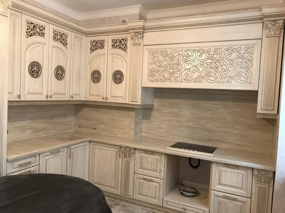Inspiration for a large traditional l-shaped eat-in kitchen in Moscow with an undermount sink, beaded inset cabinets, white cabinets, solid surface benchtops, grey splashback, shiplap splashback, black appliances, no island and beige benchtop.