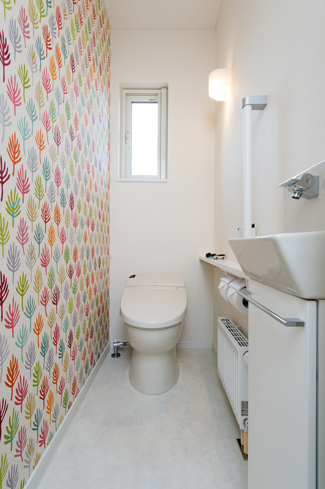 Design ideas for a scandinavian powder room in Sapporo with flat-panel cabinets, white cabinets, a one-piece toilet, white walls and white floor.