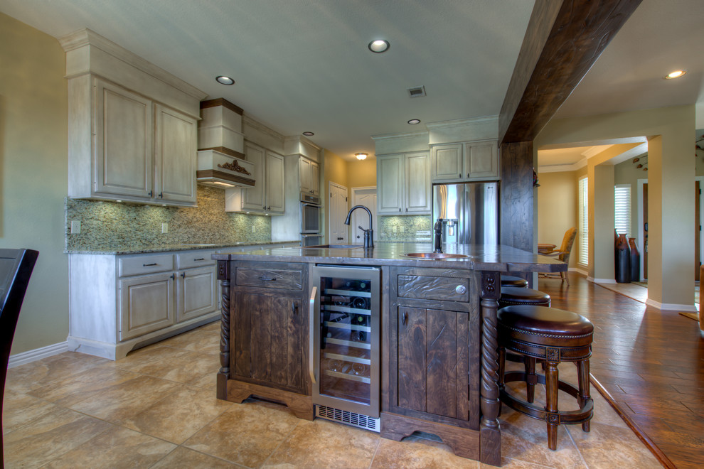 Mid-sized mountain style l-shaped eat-in kitchen photo in Austin with a single-bowl sink, wood countertops, stainless steel appliances and an island