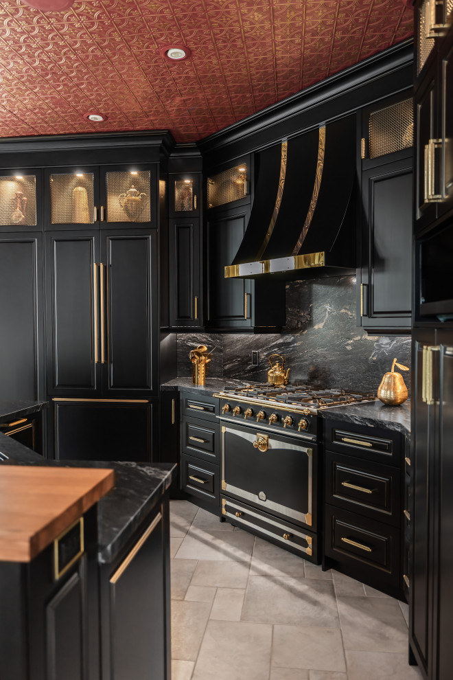 Example of a large eclectic kitchen design with raised-panel cabinets, black cabinets, granite countertops, black backsplash, granite backsplash, paneled appliances, an island and black countertops