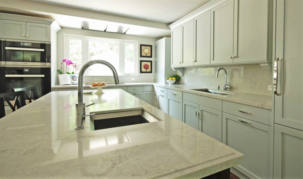 Inspiration for a mid-sized transitional l-shaped medium tone wood floor open concept kitchen remodel with an undermount sink, recessed-panel cabinets, blue cabinets, quartz countertops, white backsplash, quartz backsplash, an island and white countertops