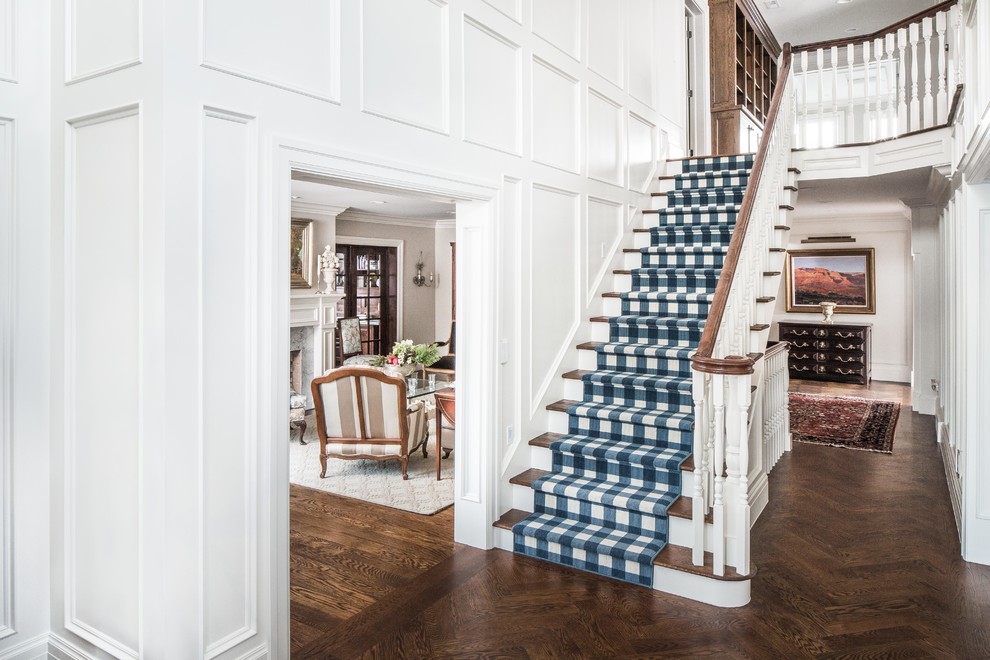 Photo of a traditional wood straight staircase in Salt Lake City with painted wood risers and wood railing.
