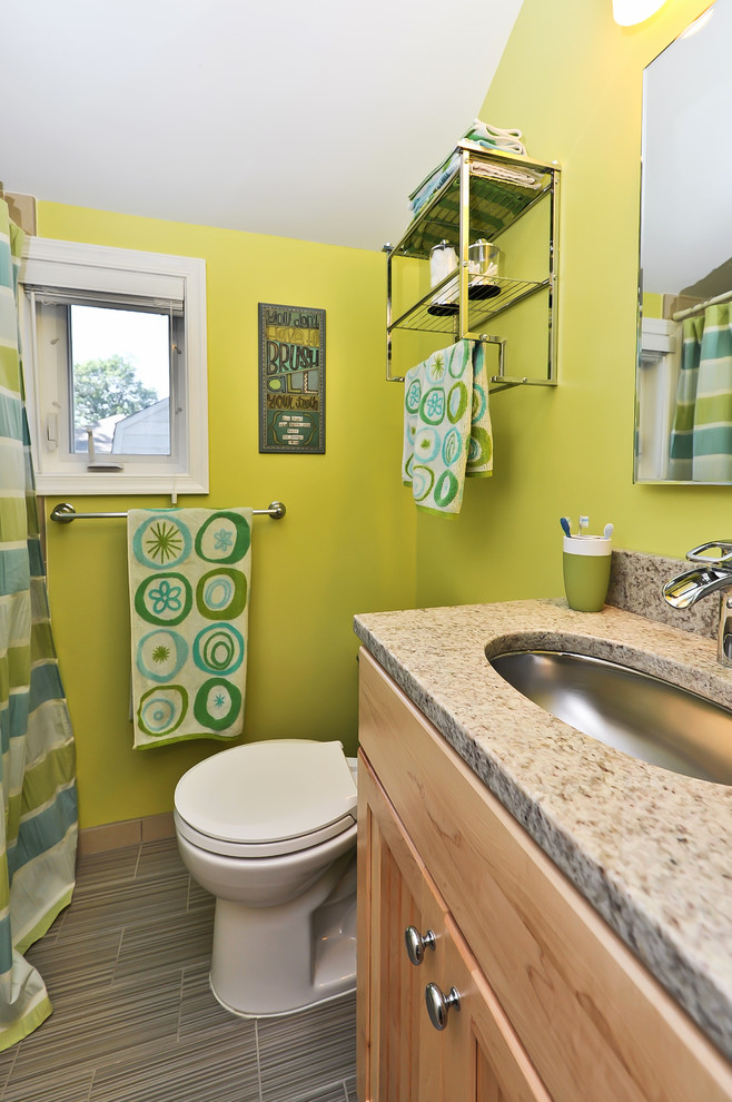 Traditional bathroom in DC Metro with an undermount sink, shaker cabinets, medium wood cabinets and a shower curtain.