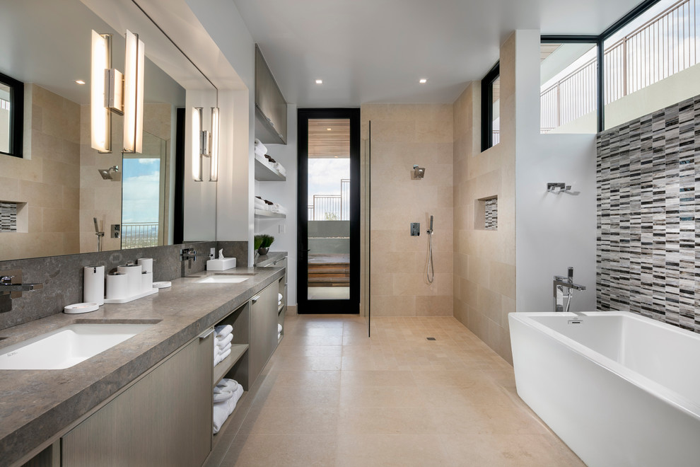 Contemporary master bathroom in Las Vegas with flat-panel cabinets, grey cabinets, a freestanding tub, a curbless shower, matchstick tile, white walls, an undermount sink, beige floor, an open shower and grey benchtops.