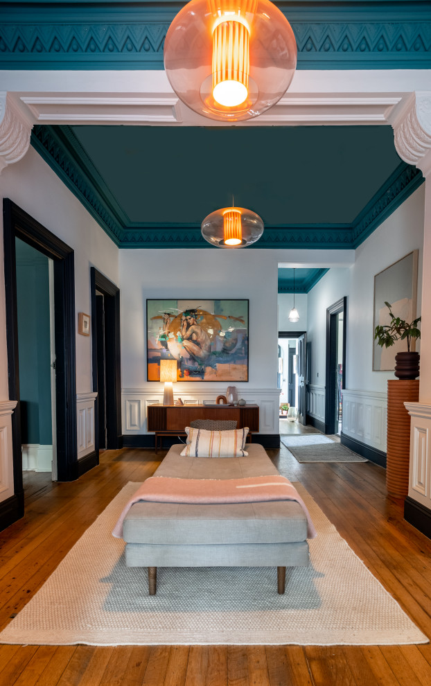 This is an example of a large eclectic entry hall in Glasgow with medium hardwood floors and brown floor.
