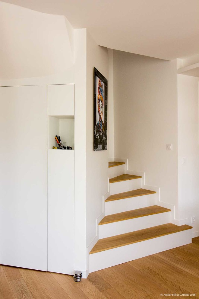 Inspiration pour un escalier peint courbe design de taille moyenne avec des marches en bois.
