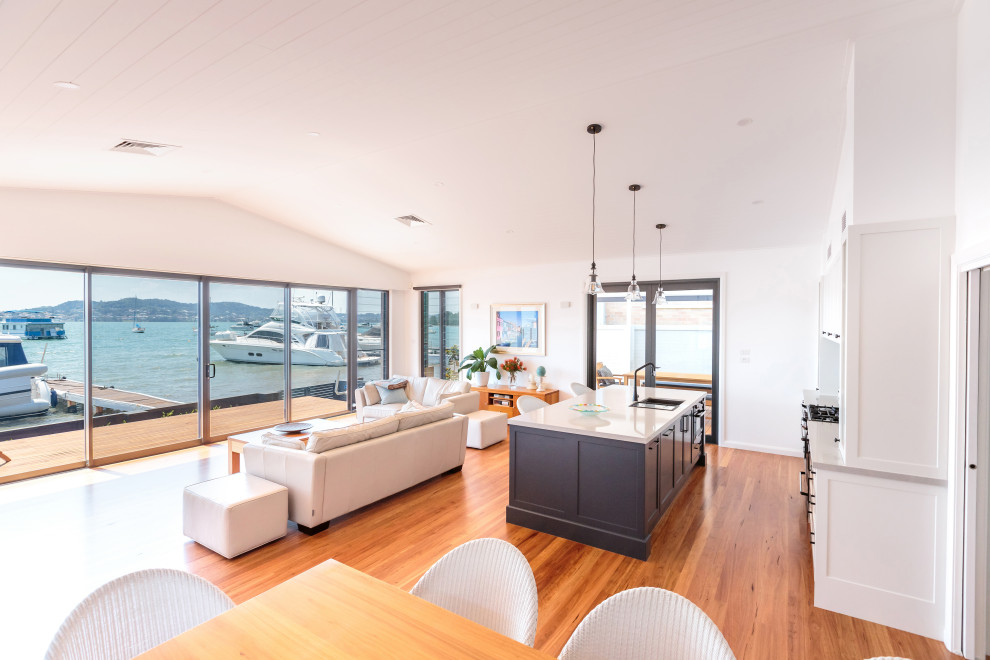 Inspiration for a large beach style galley open plan kitchen in Newcastle - Maitland with shaker cabinets, white cabinets, quartz benchtops, grey splashback, with island and white benchtop.