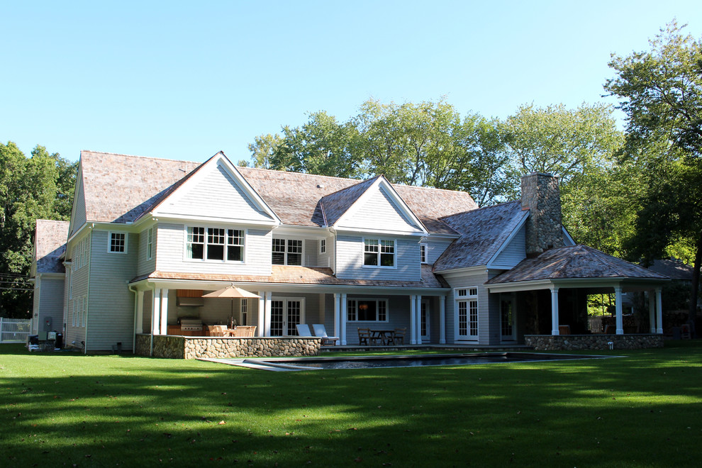 Photo of a large traditional two-storey grey exterior in New York with wood siding and a gable roof.