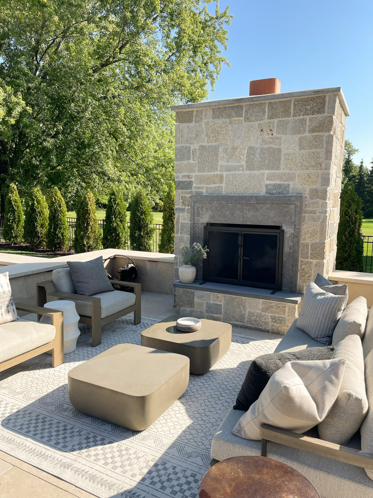 Design ideas for a large nautical back full sun garden in Minneapolis with a fireplace and natural stone paving.