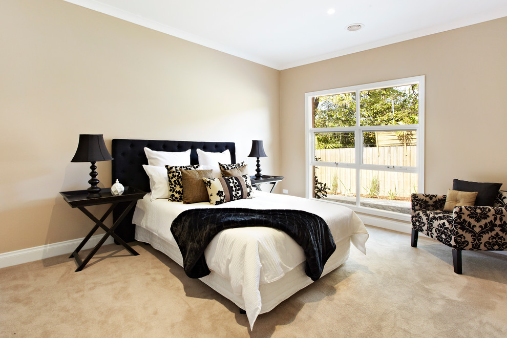 Photo of a transitional bedroom in Melbourne with beige walls, carpet and no fireplace.