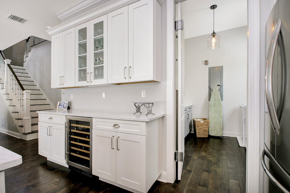Inspiration for a mid-sized beach style single-wall utility room in Tampa with shaker cabinets, grey cabinets, quartz benchtops and a side-by-side washer and dryer.