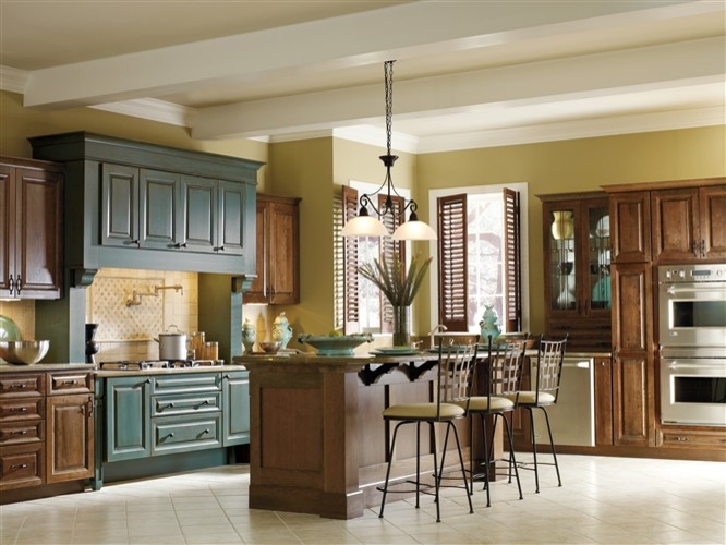 Transitional single-wall porcelain tile open concept kitchen photo in Orange County with raised-panel cabinets, dark wood cabinets, beige backsplash, stainless steel appliances and an island