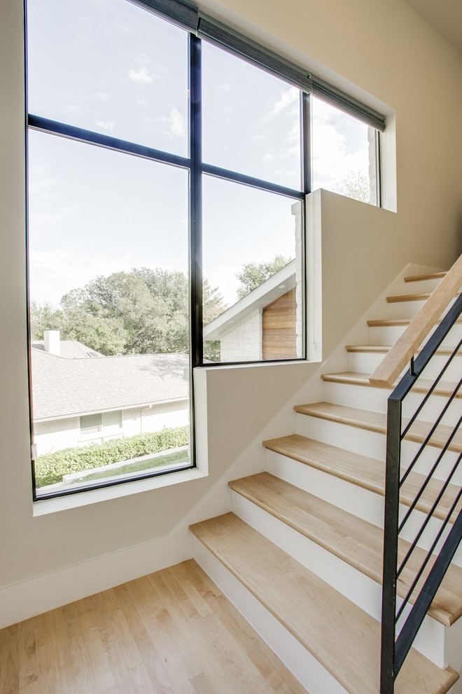 Design ideas for a mid-sized contemporary wood straight staircase in Dallas with painted wood risers and metal railing.