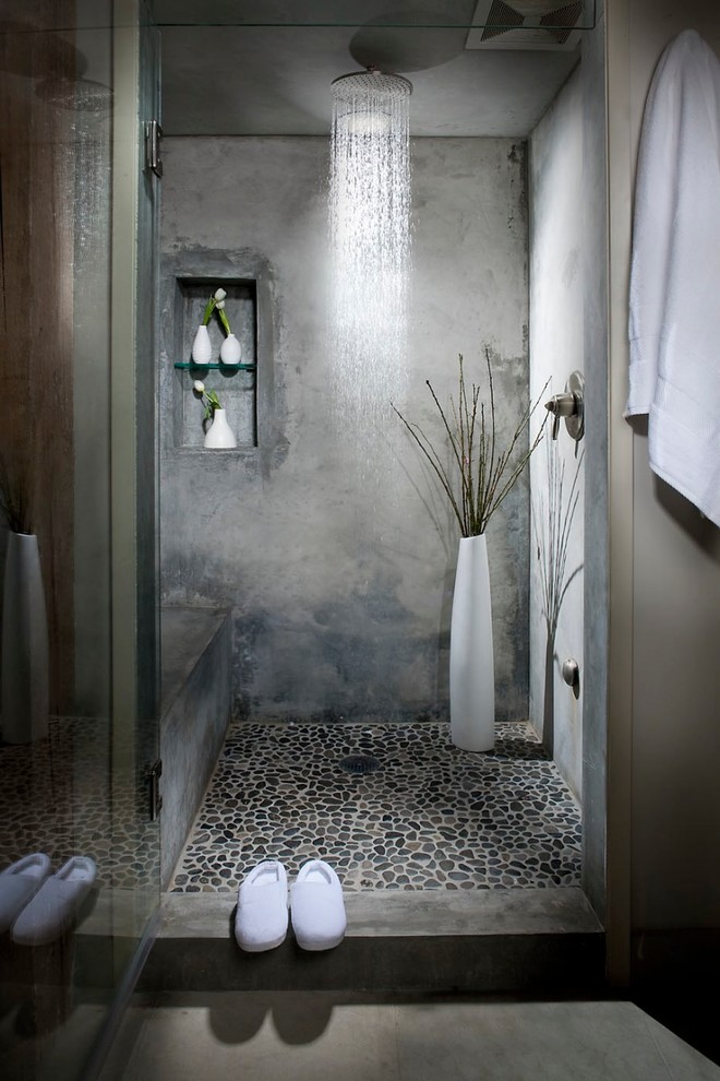 Inspiration for an industrial bathroom in San Francisco with an alcove shower, gray tile, grey walls and pebble tile floors.