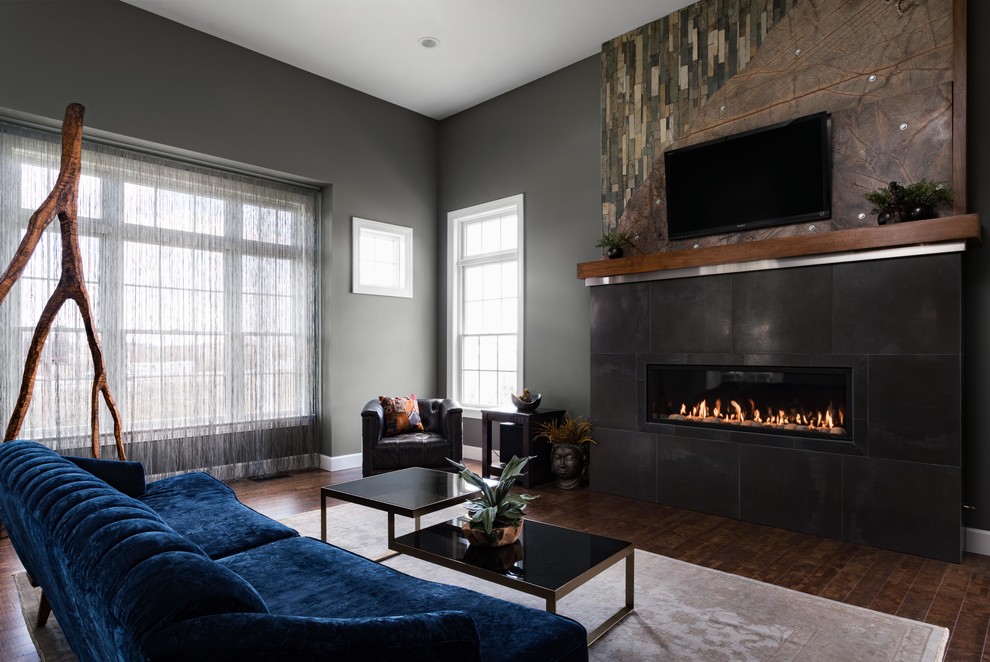Large contemporary formal open concept living room in New York with grey walls, dark hardwood floors, a ribbon fireplace, a tile fireplace surround, a wall-mounted tv and brown floor.