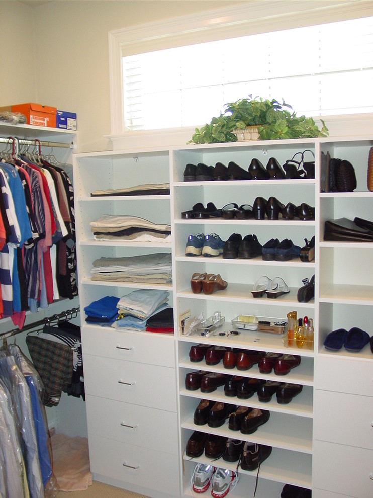 Photo of a mid-sized traditional gender-neutral walk-in wardrobe in Miami with open cabinets, white cabinets and carpet.