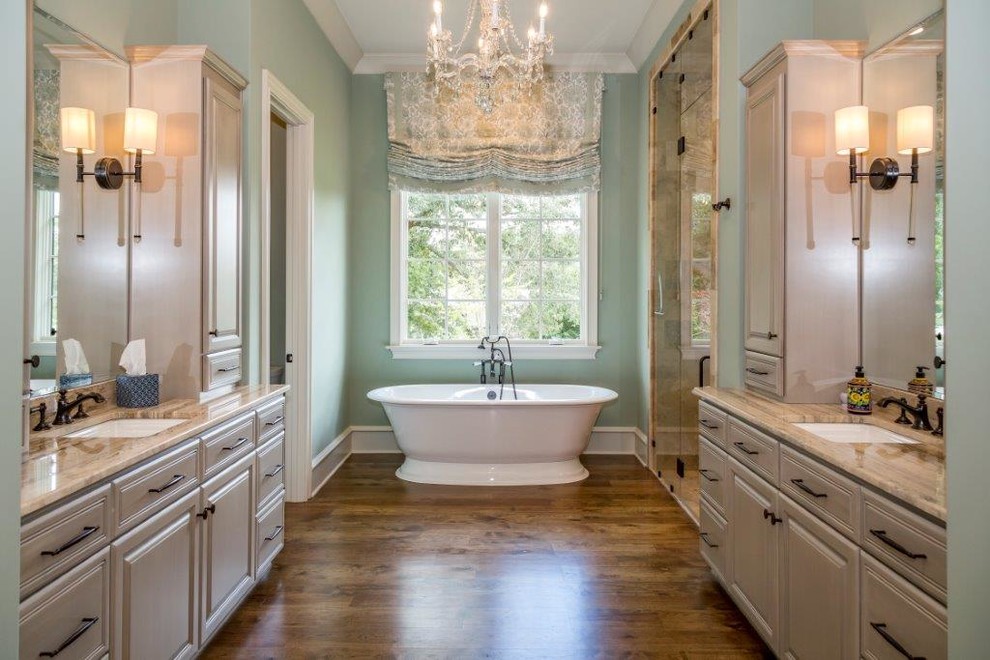 Large transitional master bathroom in Charlotte with a freestanding tub, a curbless shower, a one-piece toilet, a drop-in sink, granite benchtops, a hinged shower door and beige benchtops.