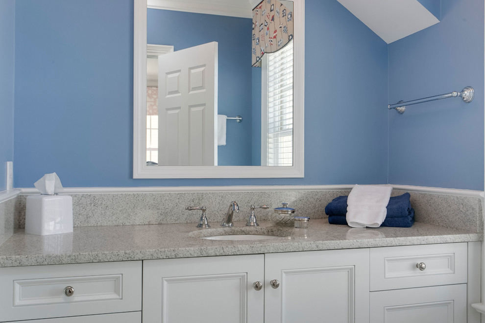 Mid-sized transitional bathroom in Raleigh with white cabinets, an undermount sink, granite benchtops, recessed-panel cabinets and blue walls.