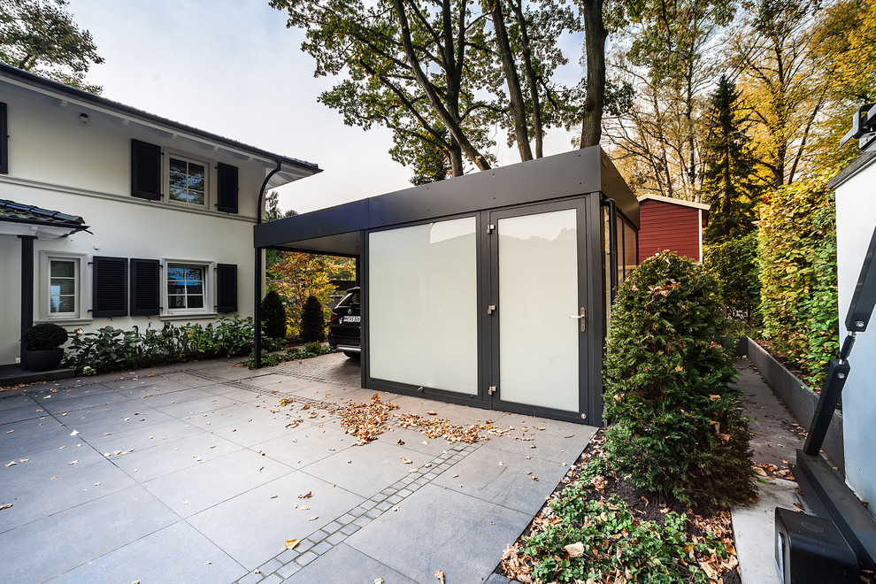This is an example of a mid-sized contemporary detached one-car carport in Hamburg.