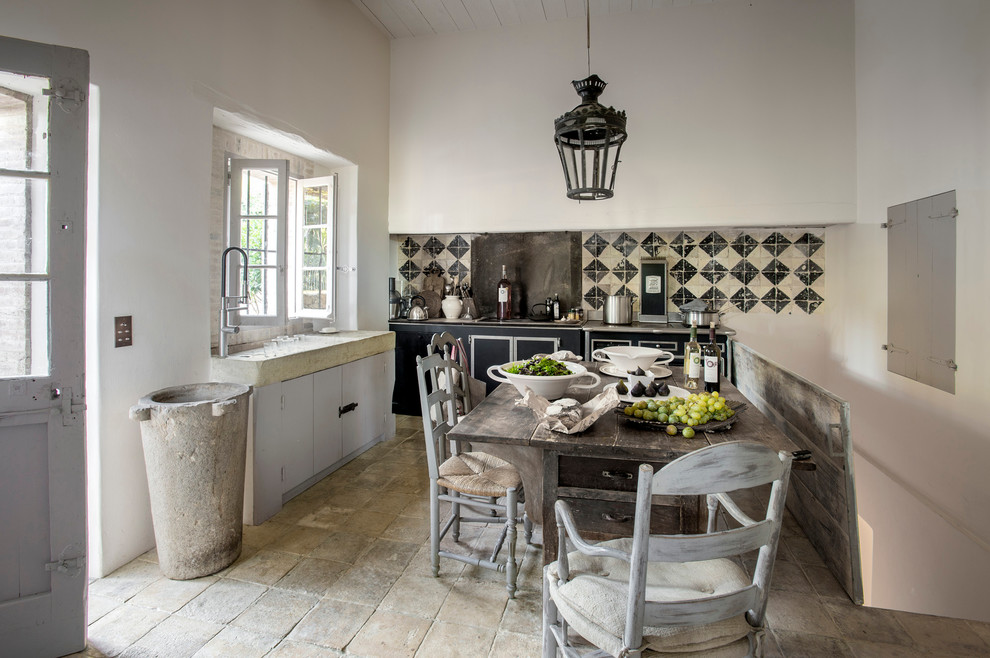 Inspiration for a mid-sized country l-shaped eat-in kitchen in Nice with flat-panel cabinets, black cabinets, multi-coloured splashback and no island.