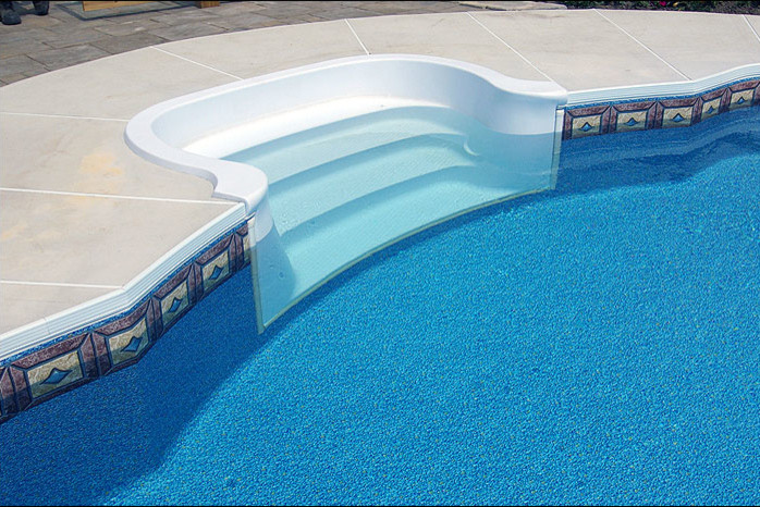 Pool - mid-sized transitional backyard concrete paver and custom-shaped lap pool idea in Toronto