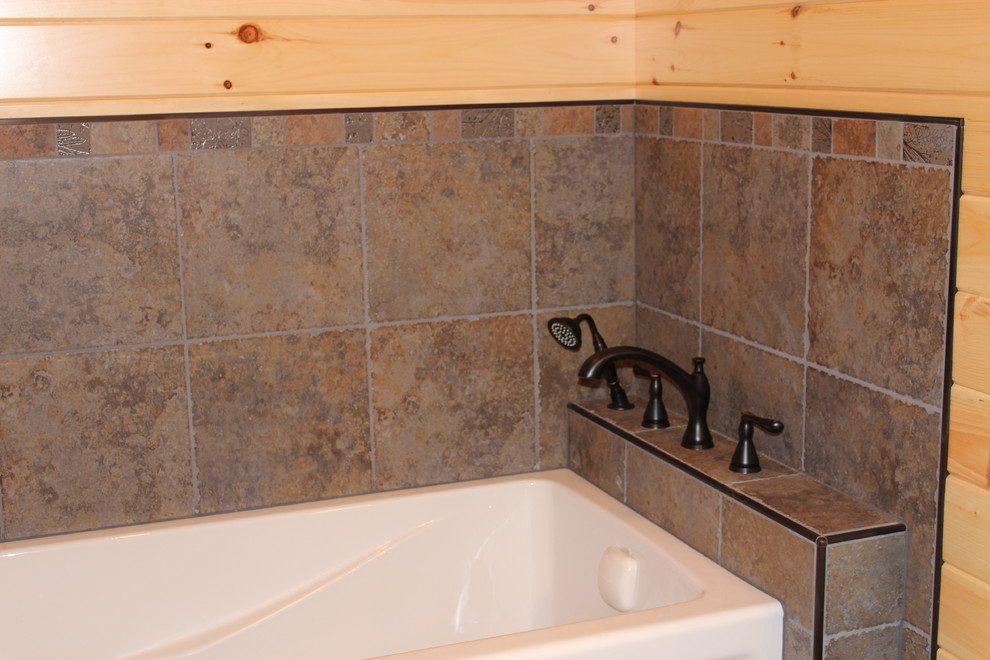 Example of a mid-sized mountain style bathroom design with shaker cabinets, medium tone wood cabinets, beige walls, an integrated sink and granite countertops