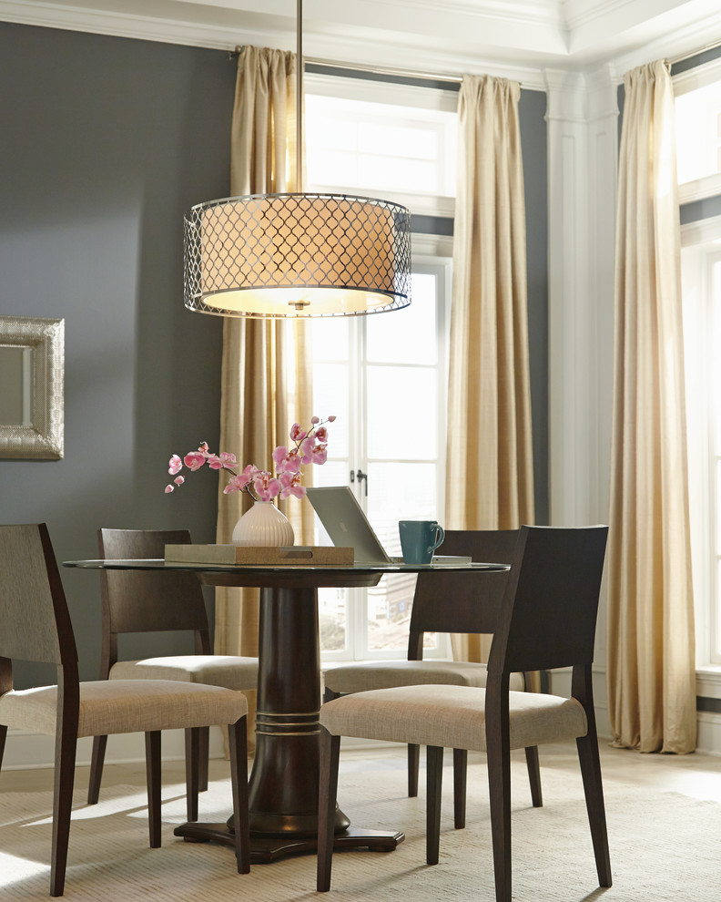 Example of a transitional dining room design with gray walls