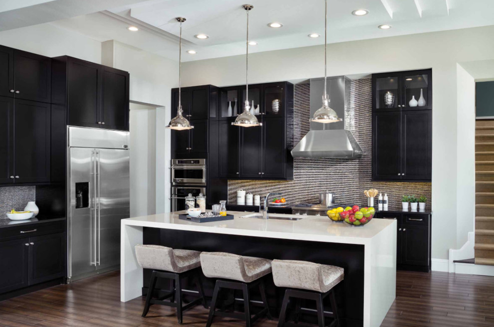 Inspiration for a large contemporary l-shaped eat-in kitchen in San Diego with an undermount sink, shaker cabinets, multi-coloured splashback, stainless steel appliances, with island, solid surface benchtops, porcelain splashback, dark hardwood floors and brown floor.
