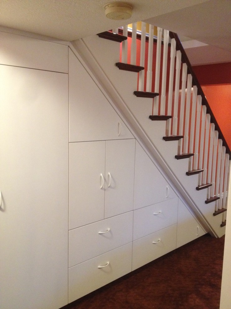 Photo of a mid-sized traditional hallway in Toronto with white walls and carpet.