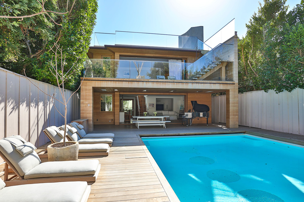 Modern backyard rectangular pool in Los Angeles with decking.