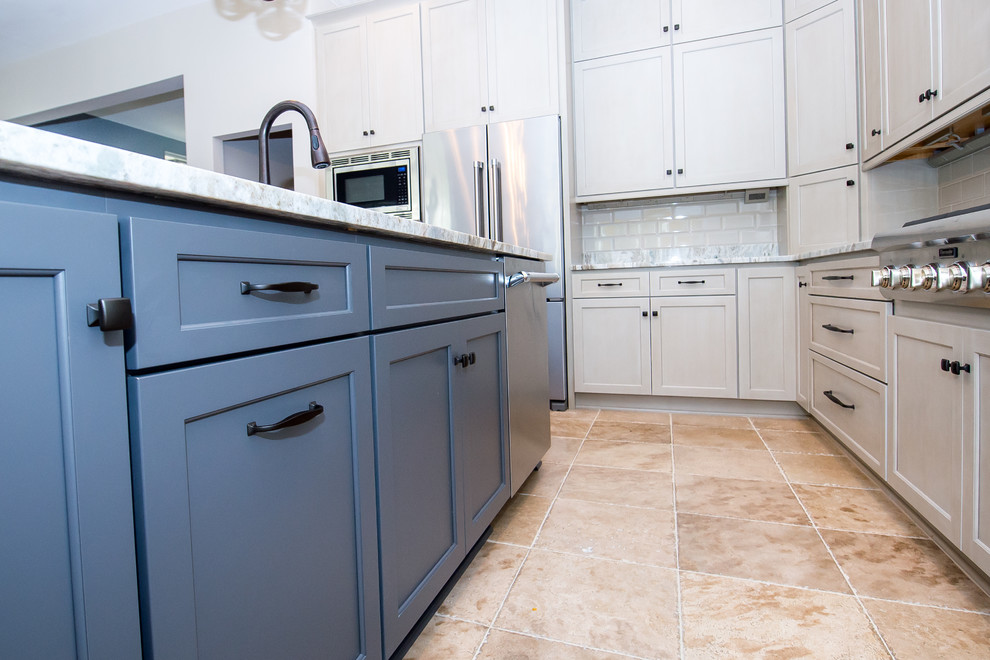 This is an example of a transitional l-shaped open plan kitchen in Charleston with a single-bowl sink, shaker cabinets, beige cabinets, granite benchtops, beige splashback, subway tile splashback, stainless steel appliances, porcelain floors and with island.