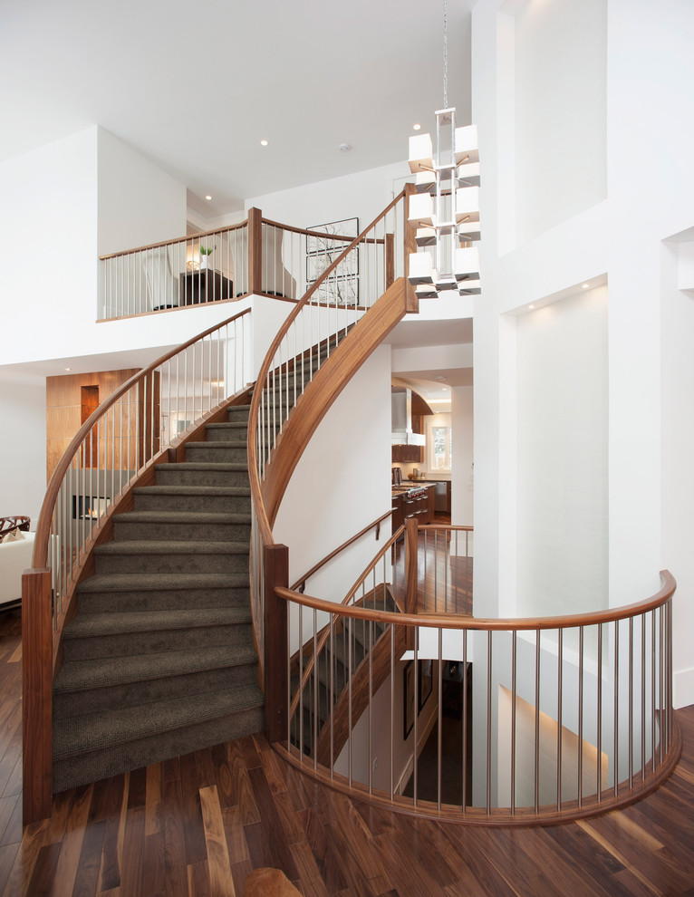 Inspiration for a contemporary carpeted staircase in Calgary with carpet risers and metal railing.