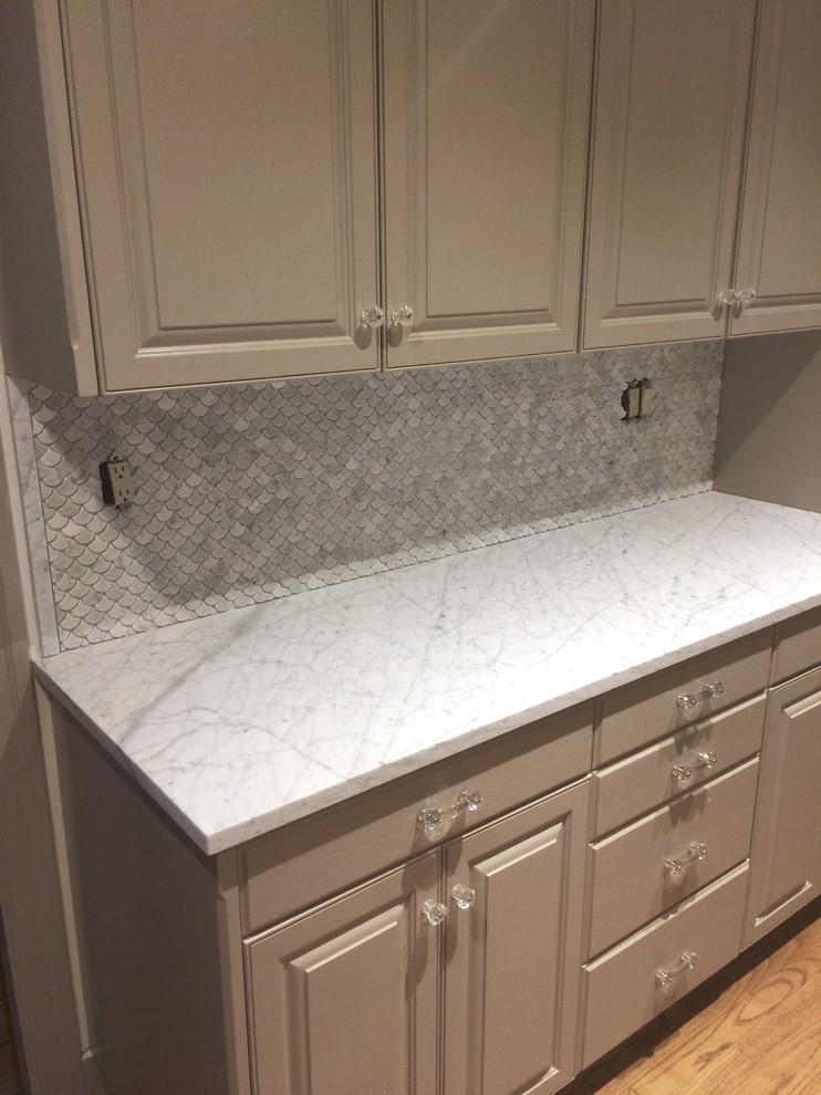 This is an example of a mid-sized traditional u-shaped kitchen pantry in Seattle with a farmhouse sink, raised-panel cabinets, grey cabinets, marble benchtops, multi-coloured splashback, mosaic tile splashback, stainless steel appliances, medium hardwood floors and with island.