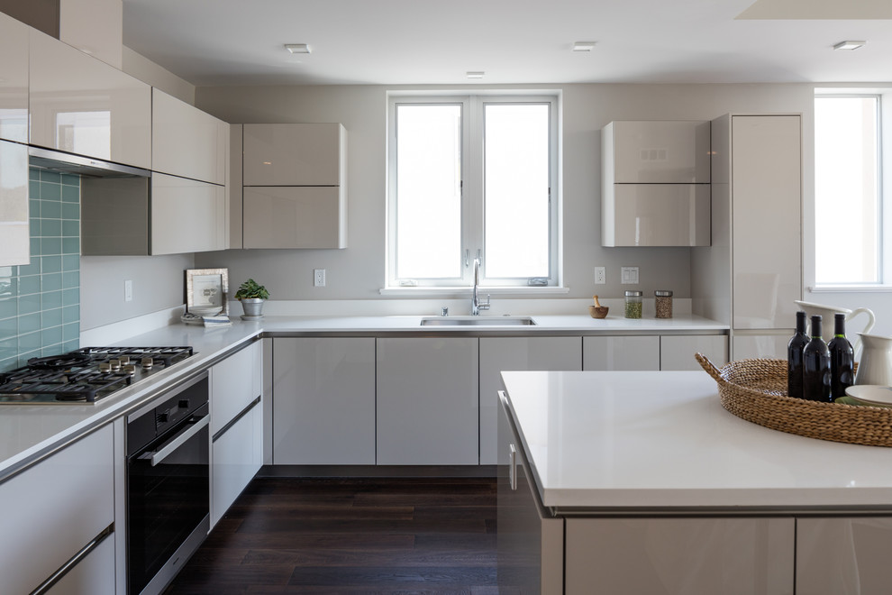 Inspiration for a contemporary eat-in kitchen in Los Angeles with an undermount sink, flat-panel cabinets, white cabinets, medium hardwood floors and with island.
