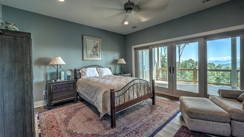 Design ideas for a medium sized classic guest bedroom in Atlanta with blue walls, laminate floors and brown floors.