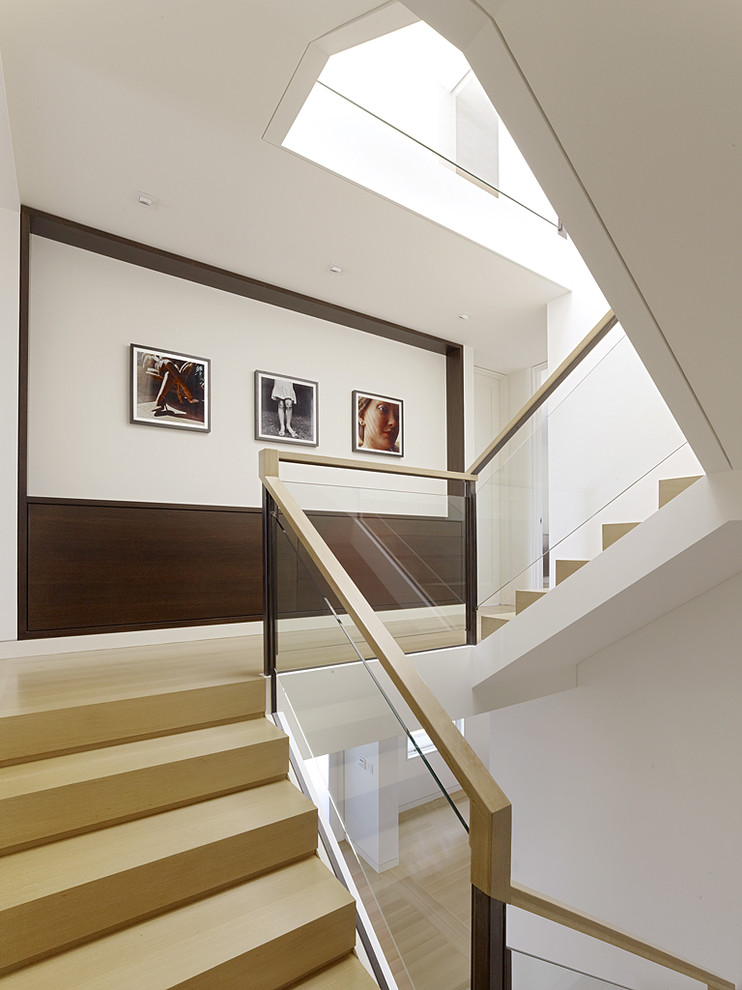 Inspiration for a modern u-shaped staircase in San Francisco with glass railing.