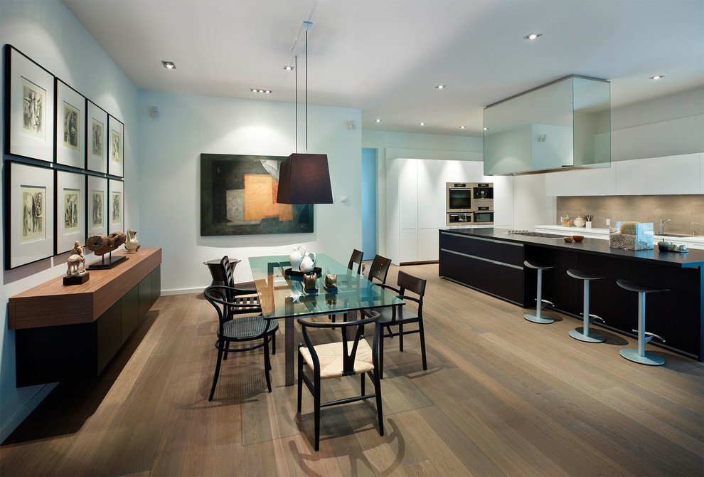 This is an example of a large contemporary kitchen/dining combo in Toronto with blue walls, medium hardwood floors and no fireplace.