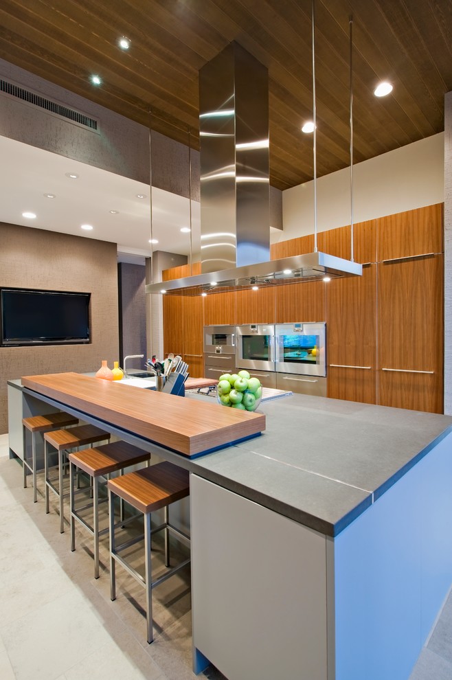 This is an example of a large contemporary l-shaped open plan kitchen in San Francisco with an undermount sink, flat-panel cabinets, light wood cabinets, zinc benchtops, stainless steel appliances, porcelain floors, with island and beige floor.