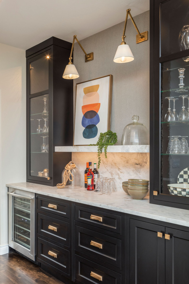 This is an example of a mid-sized transitional galley home bar in Denver with dark wood cabinets, marble benchtops, white splashback, marble splashback, dark hardwood floors, brown floor and white benchtop.