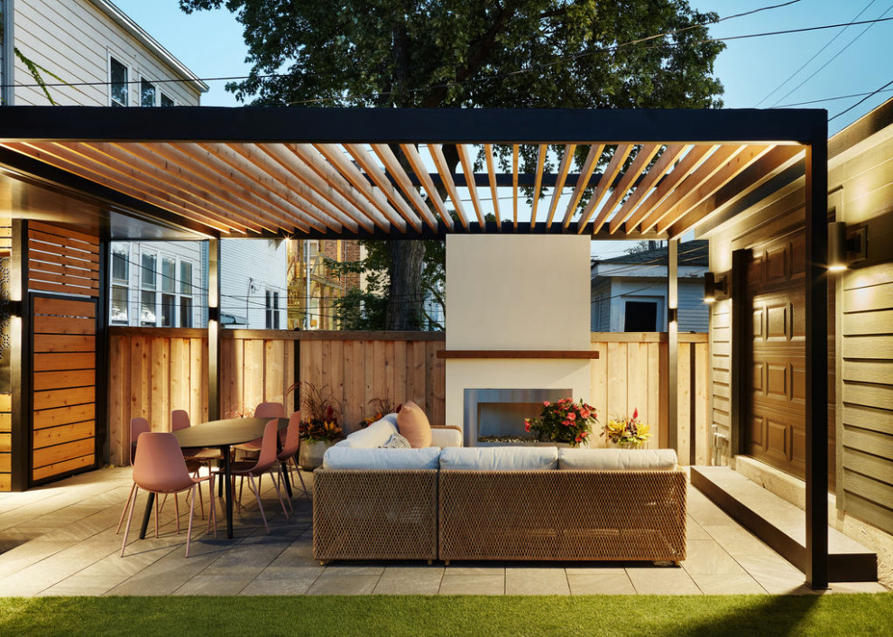 Photo of a modern backyard patio in Chicago with with fireplace and a pergola.