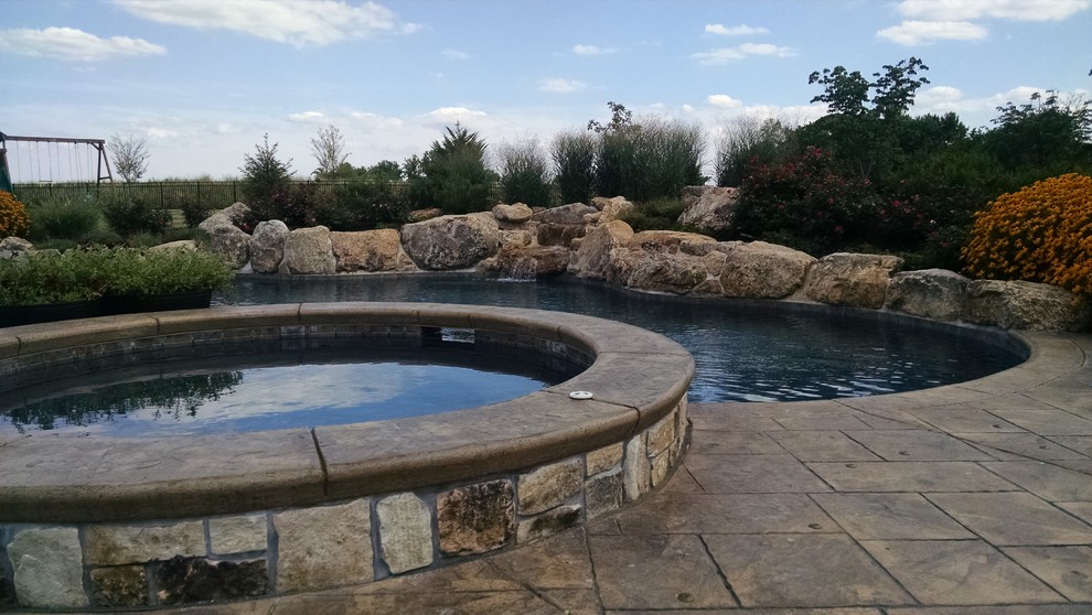 Example of a large mountain style backyard custom-shaped natural pool design in New York