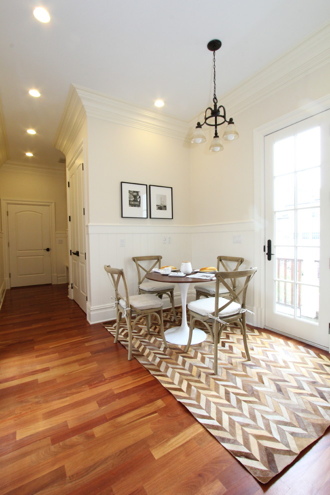 Photo of a small modern dining room in New York with white walls and medium hardwood floors.