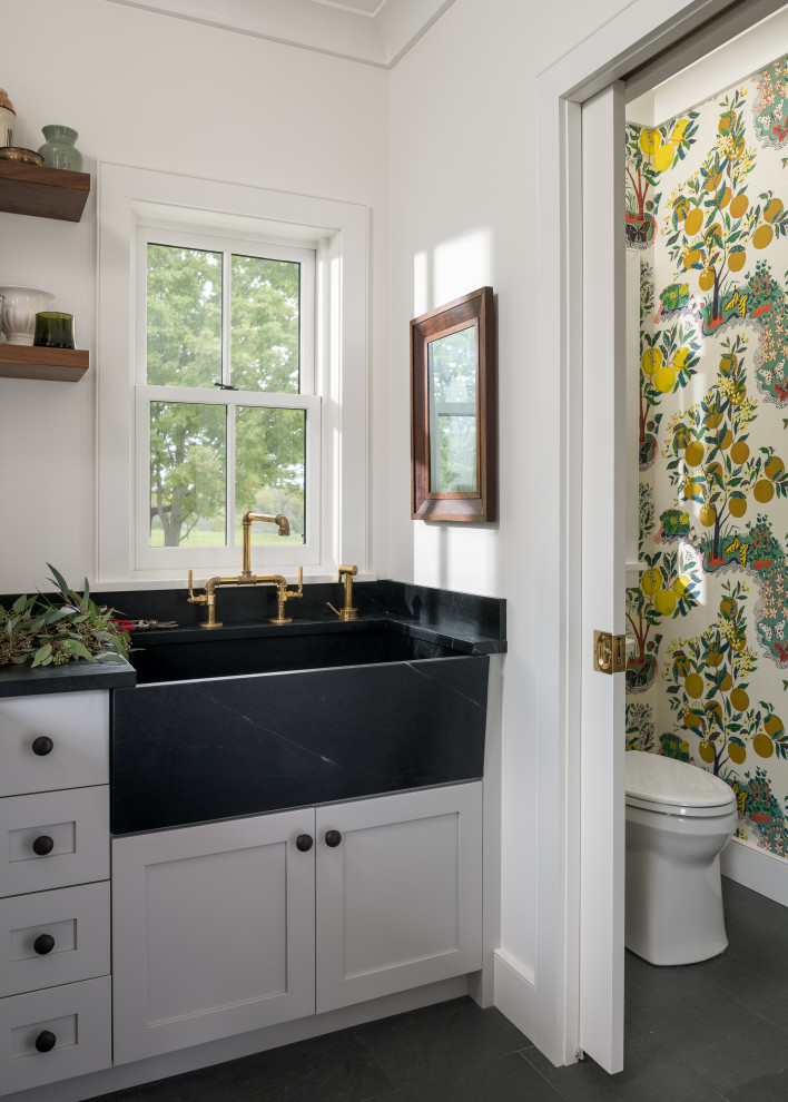 Photo of a small country powder room in Burlington with a two-piece toilet, a pedestal sink, a freestanding vanity and wallpaper.