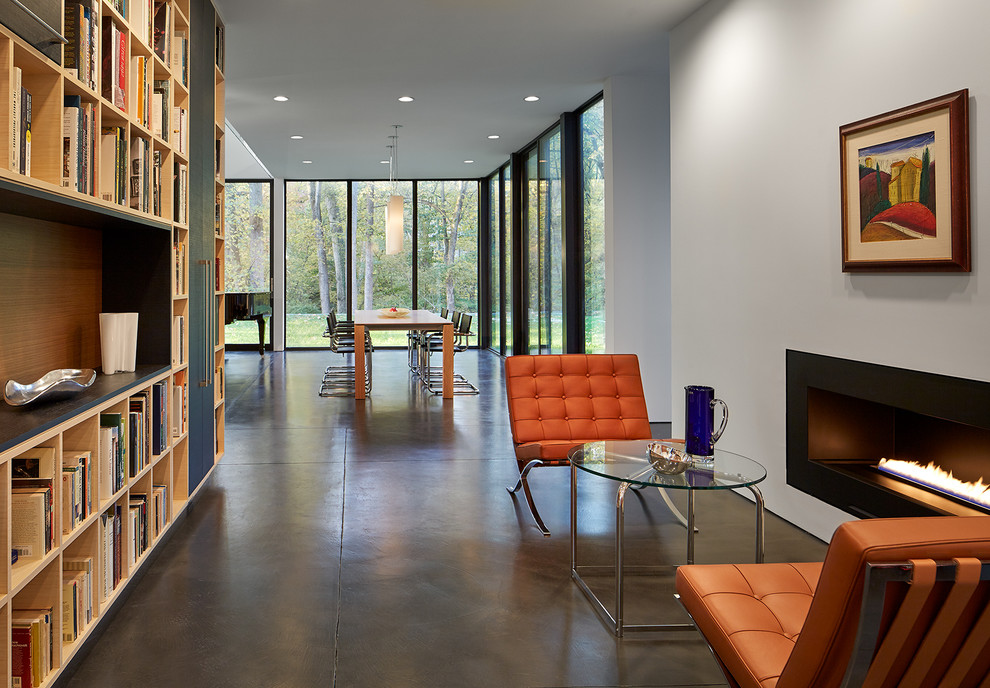 Inspiration for a contemporary open concept family room in DC Metro with a library, white walls, concrete floors, a ribbon fireplace, no tv and grey floor.
