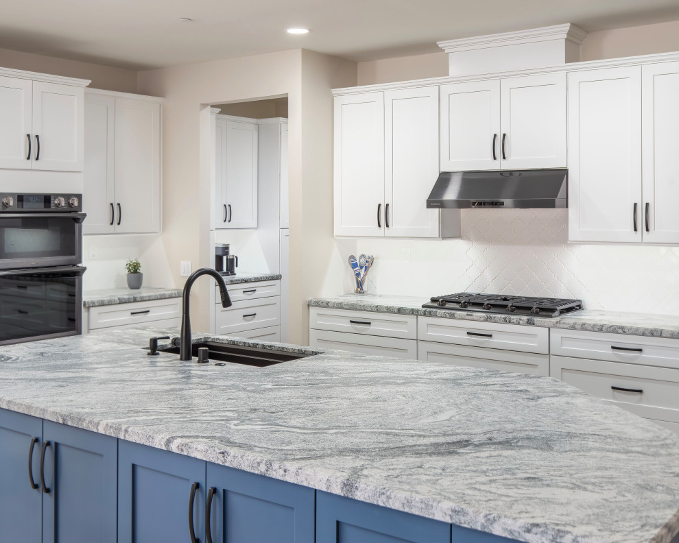 Large transitional laminate floor and blue floor kitchen photo in Los Angeles with a single-bowl sink, shaker cabinets, blue cabinets, granite countertops, white backsplash, ceramic backsplash, black appliances, an island and gray countertops