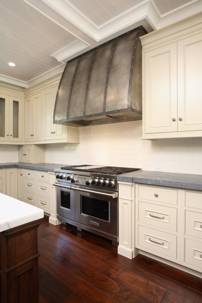 This is an example of a traditional kitchen in San Francisco with beaded inset cabinets and beige cabinets.