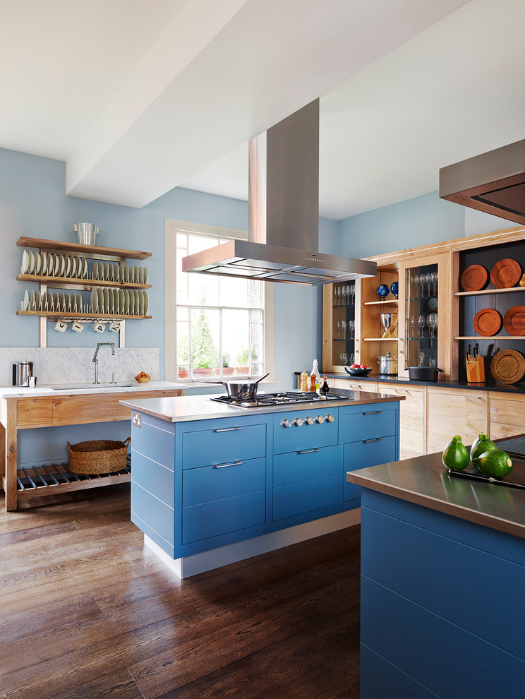 This is an example of a country kitchen in London with flat-panel cabinets, blue cabinets, dark hardwood floors and multiple islands.