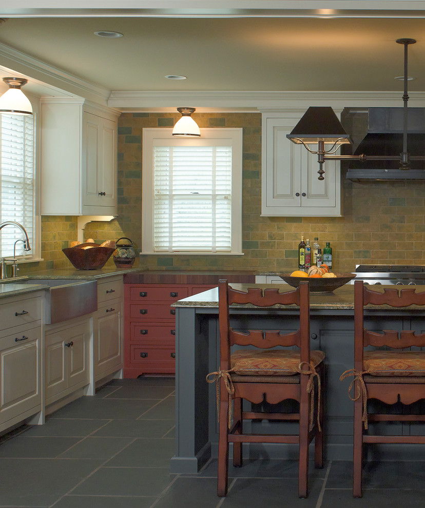 Country kitchen in Minneapolis with a farmhouse sink, slate floors and slate splashback.