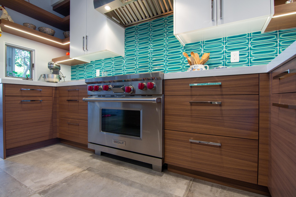 Inspiration for a large midcentury galley kitchen in San Diego with a submerged sink, flat-panel cabinets, green splashback, stainless steel appliances, an island, grey floors, beige worktops and a timber clad ceiling.